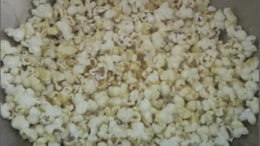 A bowl full of fluffy, popped popcorn.