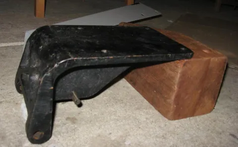 A close-up of a hand holding a small white tag that reads 'MADE IN ITALY' in black capital letters, next to a small Italian flag symbol.