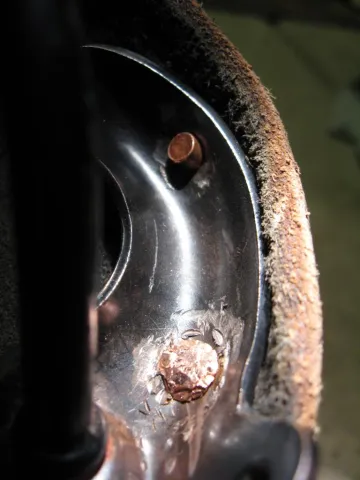 A hand holds a smartphone displaying a QR code on its screen.