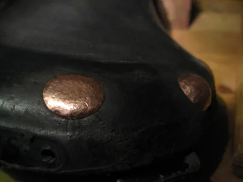 A highly detailed close-up of a human eye, featuring a blue iris, a dark pupil reflecting light, and prominent eyelashes.