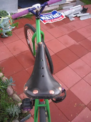 A detailed close-up of a bright blue human eye, showing the iris, pupil, and individual eyelashes.
