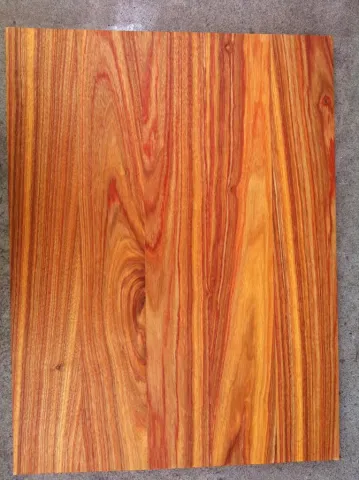 Vibrant red and orange canary wood board with unique, flowing grain patterns.