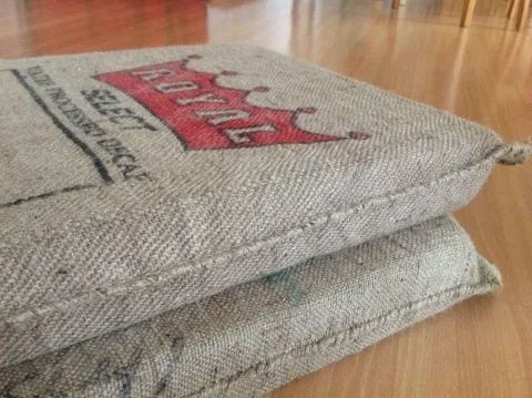Stacked burlap bags, top one featuring a red "ROYAL" crown logo.